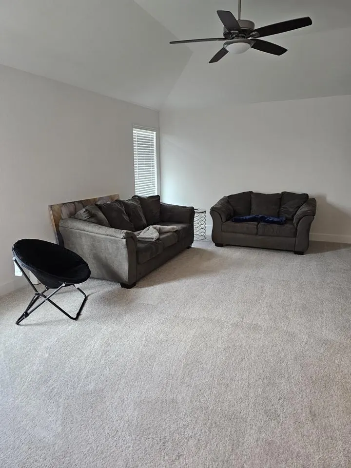 Living room with two gray couches on light carpet